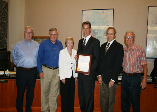 Paul D. Jones II is honored at the July 11 Board meeting. Jones, third from right, is joined from left by Board members Peer Swan, John Withers, Mary Aileen Matheis, Board President Steve LaMar and Board Member Doug Reinhart.